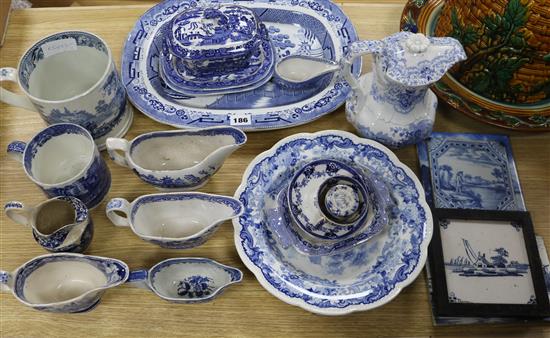 A collection of mainly 19th century Staffordshire blue and white pottery, together with various delft tiles